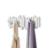 An Umbra Sticks Multi Hook - White wall coat rack with flip-down hooks for home organization.
