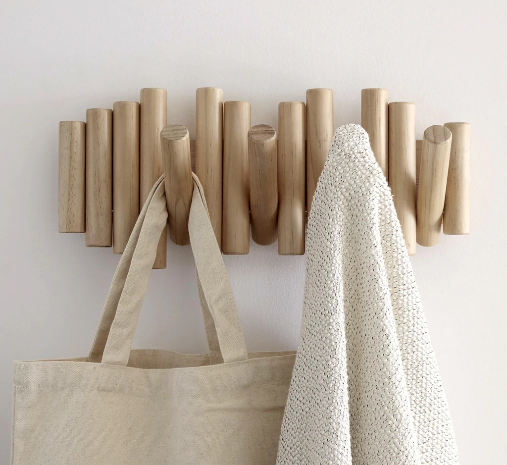 Umbra Picket rail wall hook in pine holding a canvas tote and knitted throw