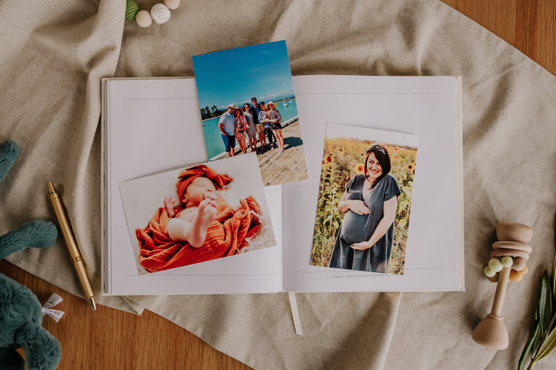 An Olive + Page - Hold The Moments Journal featuring photos and a teddy bear.