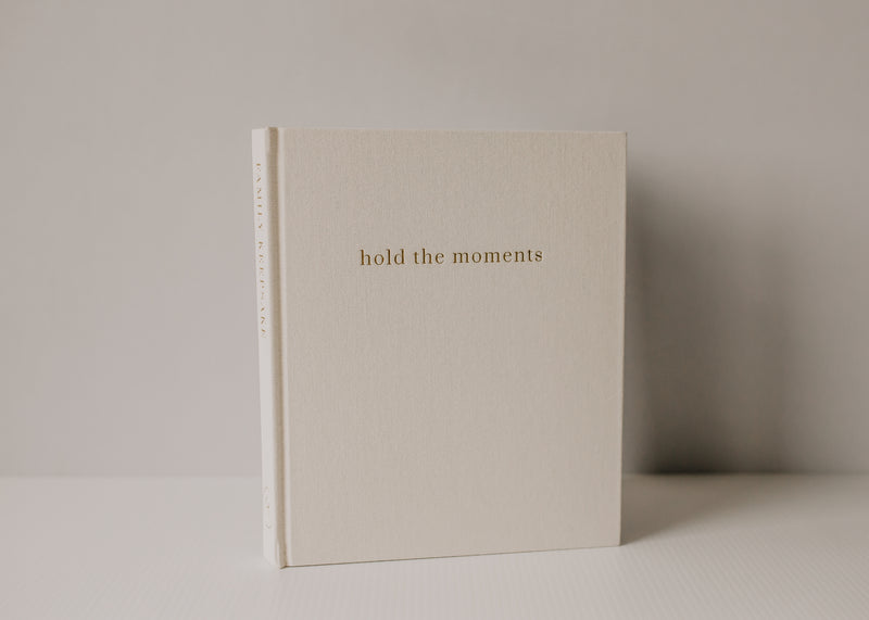 A family book with the words Olive + Page - Hold The Moments Journal on it.