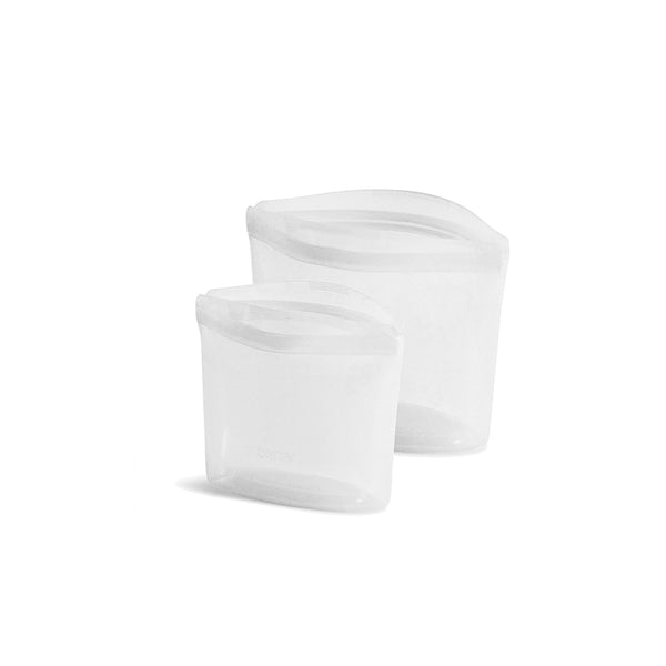 Two Stasher white plastic containers on a white surface.
