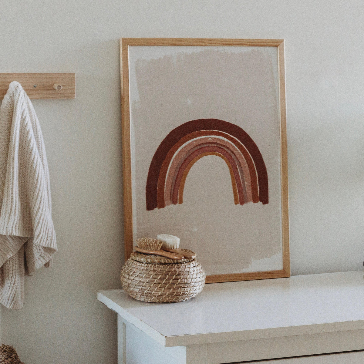 Boho Rainbow print in a timber frame above a white bench in a nursery