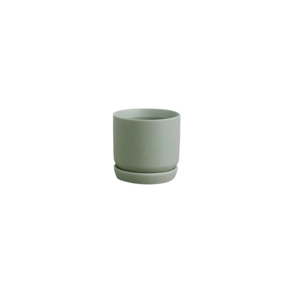 An Oslo Planter - Sage Mini, a small green stoneware planter by Potted, displayed on a white background.
