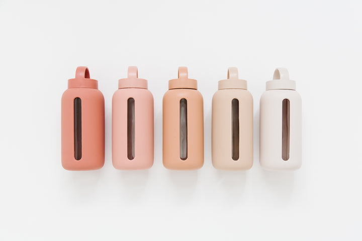 Five different colored Bink Day Bottles with Hydration Tracker - Various Options lined up on a white surface.