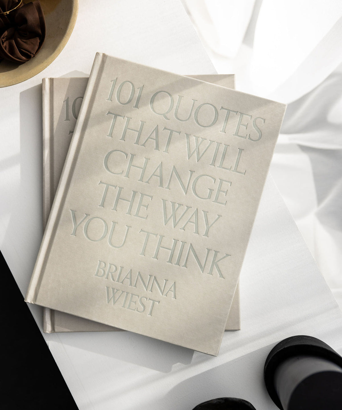 101 Quotes That Will Change The Way You Think book styled with neutral decor