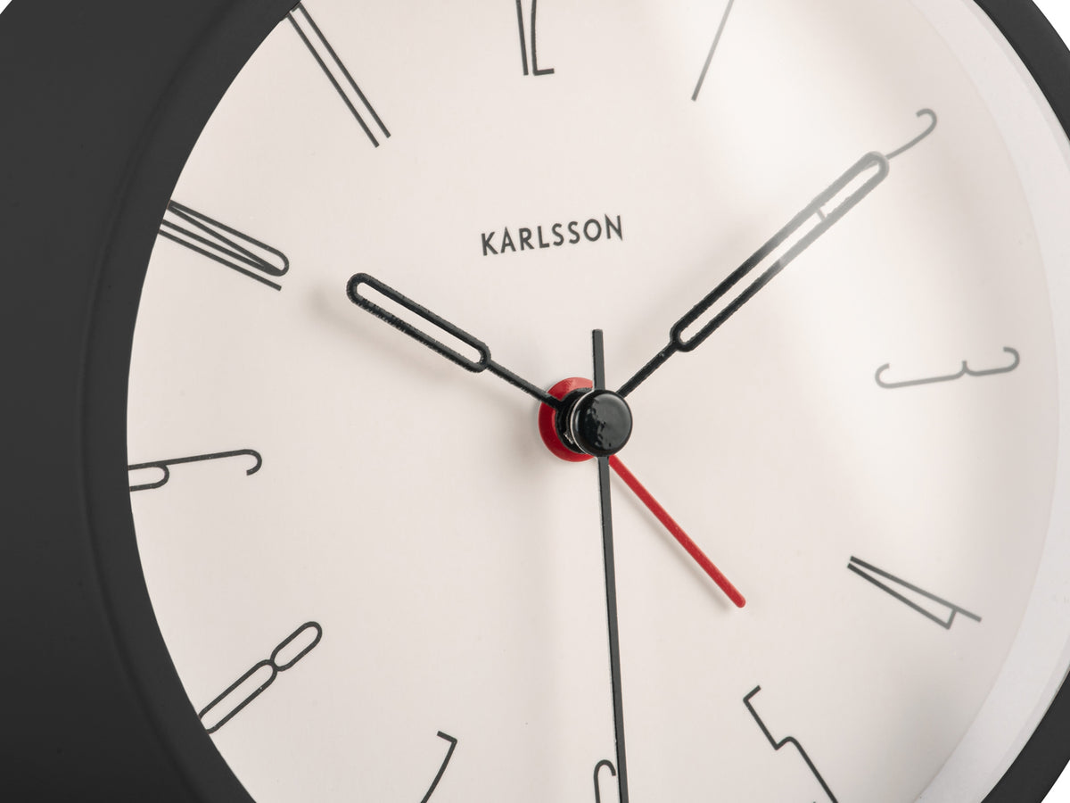 Close-up of the Black Belle alarm clock's white dial and red second hand