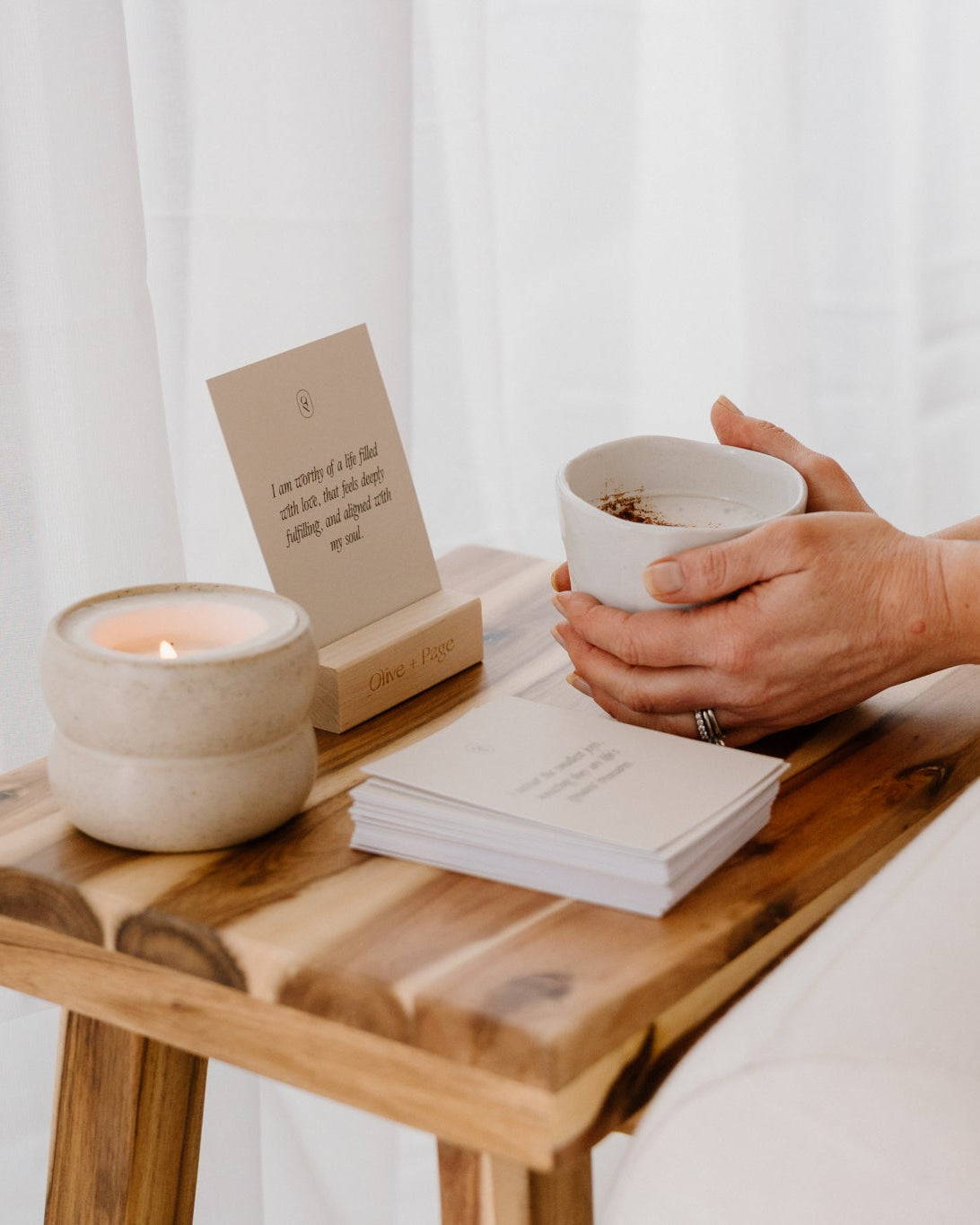 Card deck and stand on a bed tray with a cup of coffee
