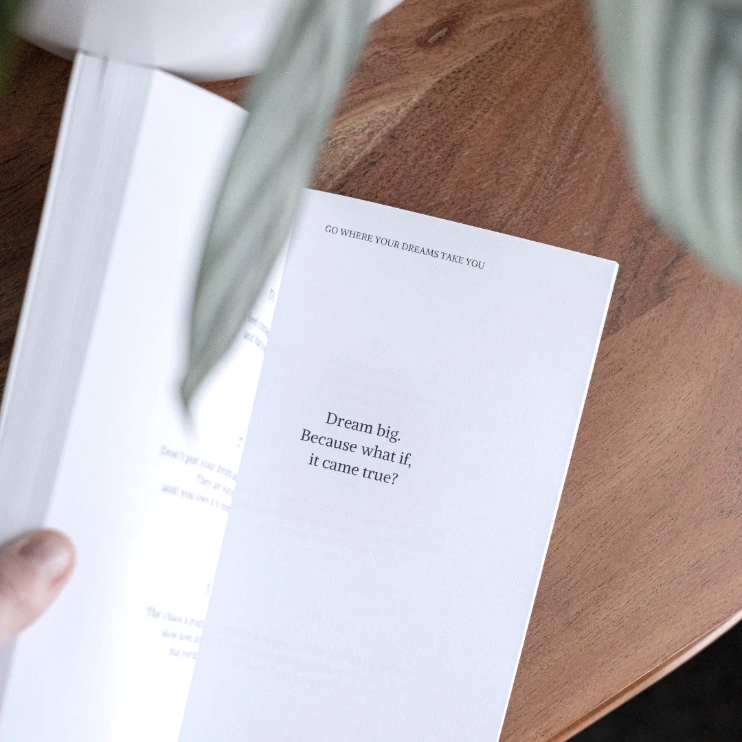 Hand holding the book open at a printed reminder