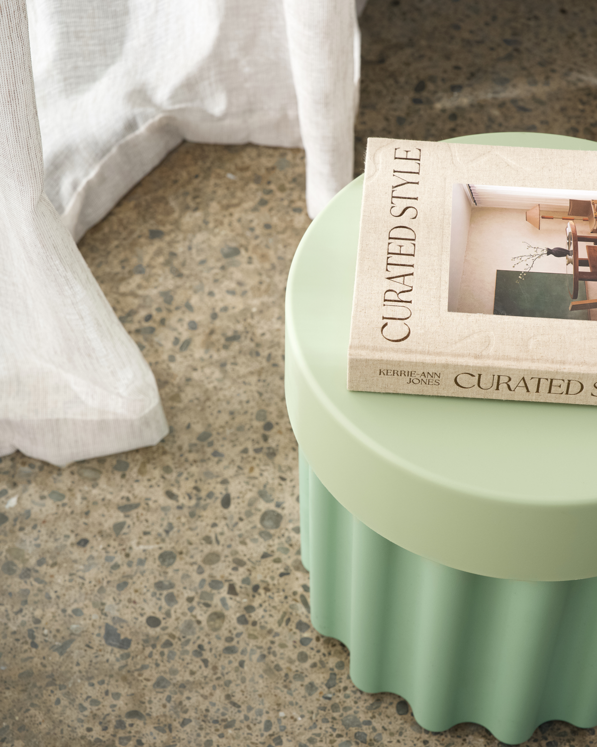 Harry Storage Stool used as a bedside table alternative