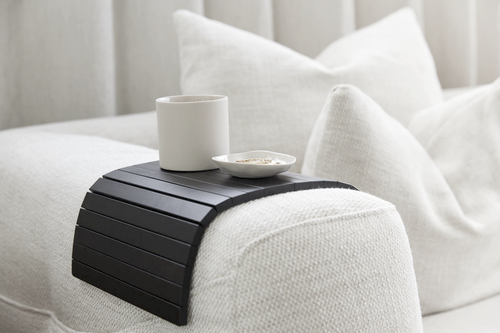 Arm chair side rest sofa tray by Ned Collections in oak, styled on a neutral armchair