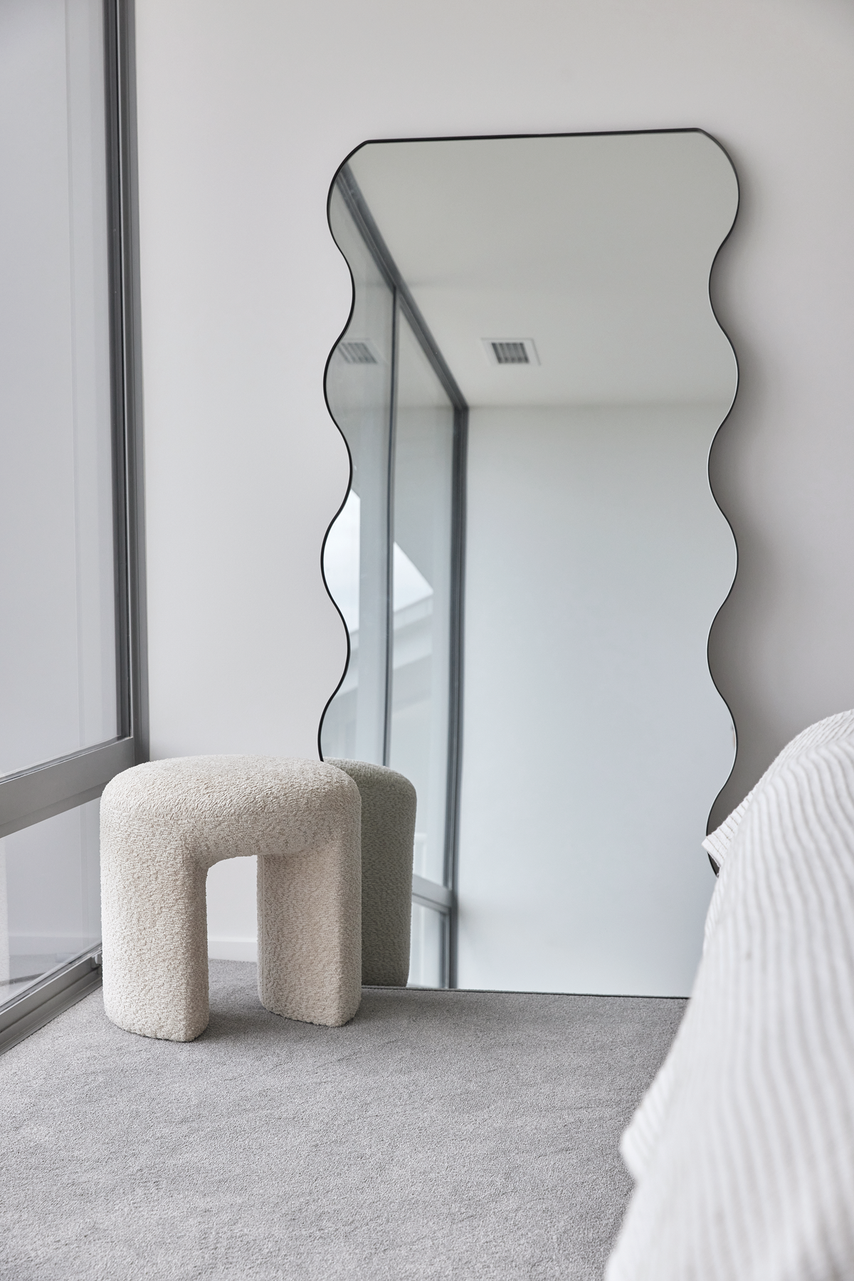 Arch floor mirror styled in a living room corner