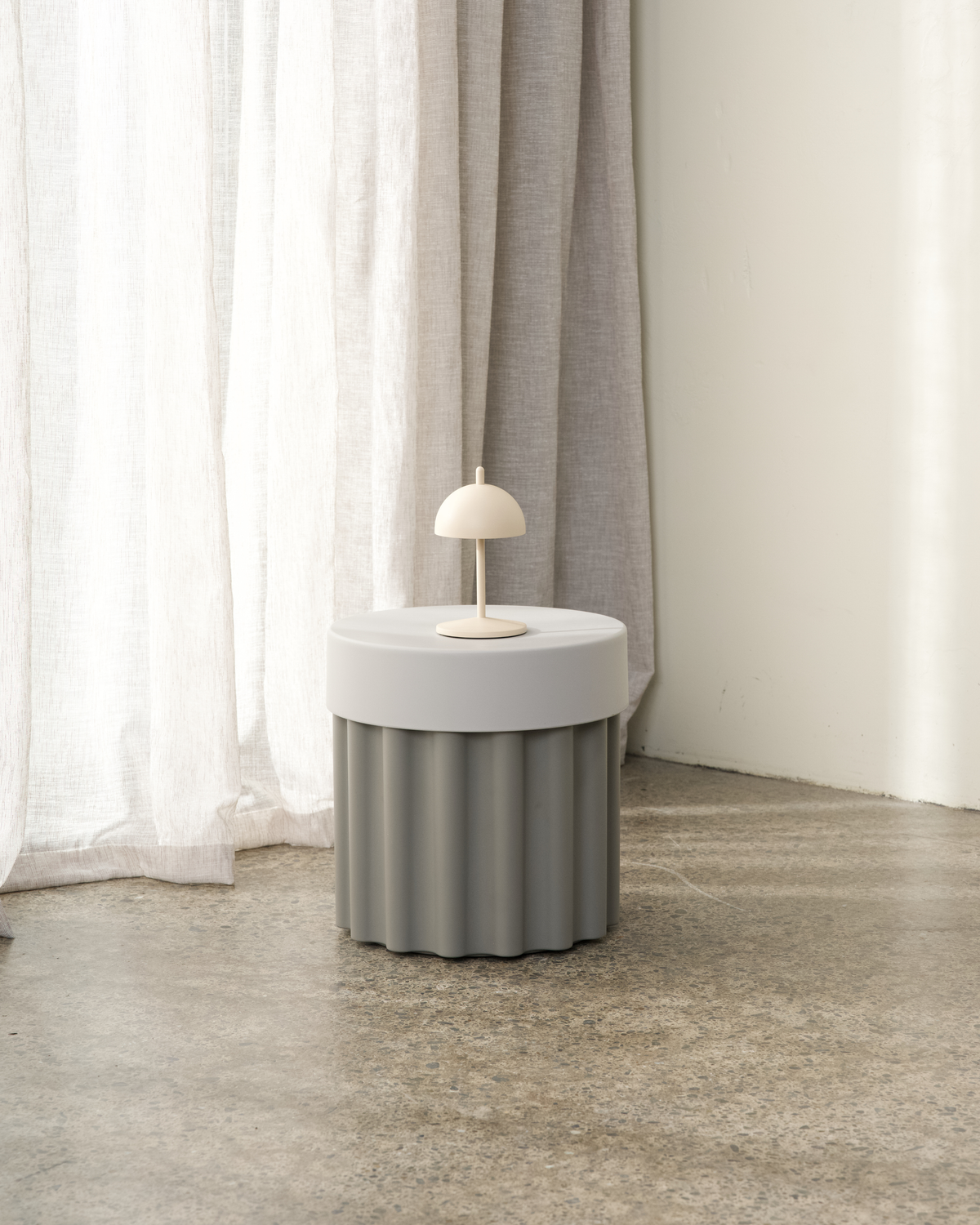 Harry Storage Stool styled beside a sofa