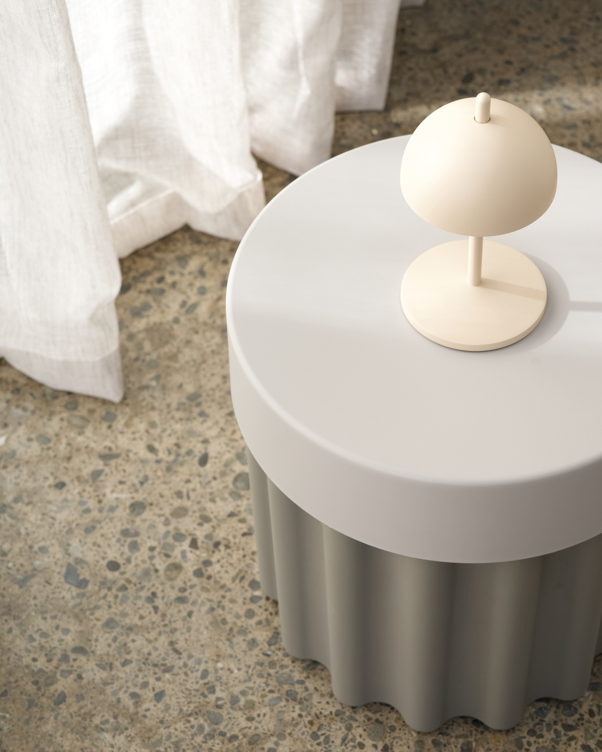Harry Storage Stool styled in a bathroom holding towels