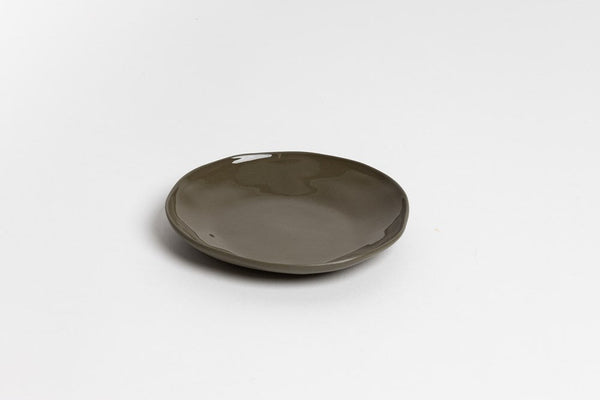 An organic Haan Round Dish on a white surface by Ned Collections.