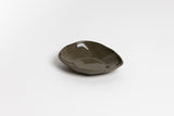 A small Ned Collections Haan Condiment Dish, made of stoneware, sitting on a white surface.