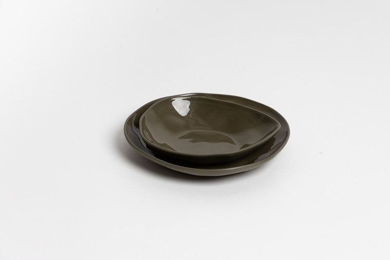 The Ned Collections Haan Condiment Dish, made of stoneware, sits elegantly on a white surface, exuding an organic feel.