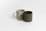 Two Jon Boy mugs from Ned Collections sitting on a white surface, exuding an organic feel with their stoneware design.