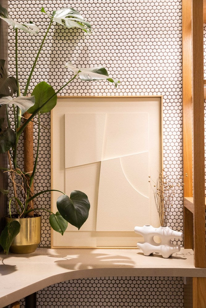 A white shelf with a Laan Print by Ned Collections and a piece of art.
