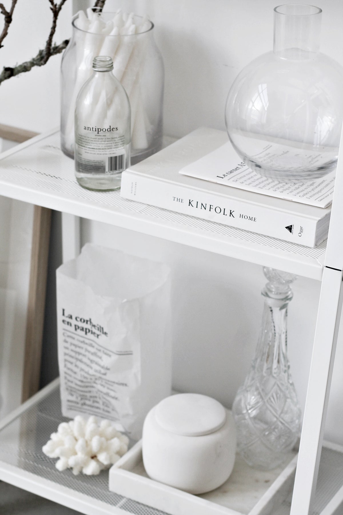 The Kinfolk Home book styled on a shelf with neutral home decor