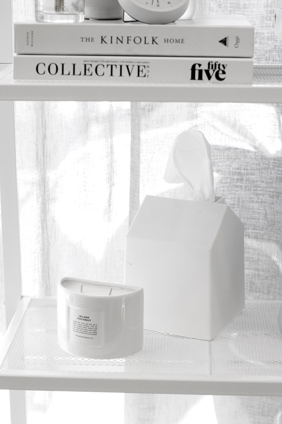 Umbra Casa white house-shaped tissue box cover styled on a bathroom shelf