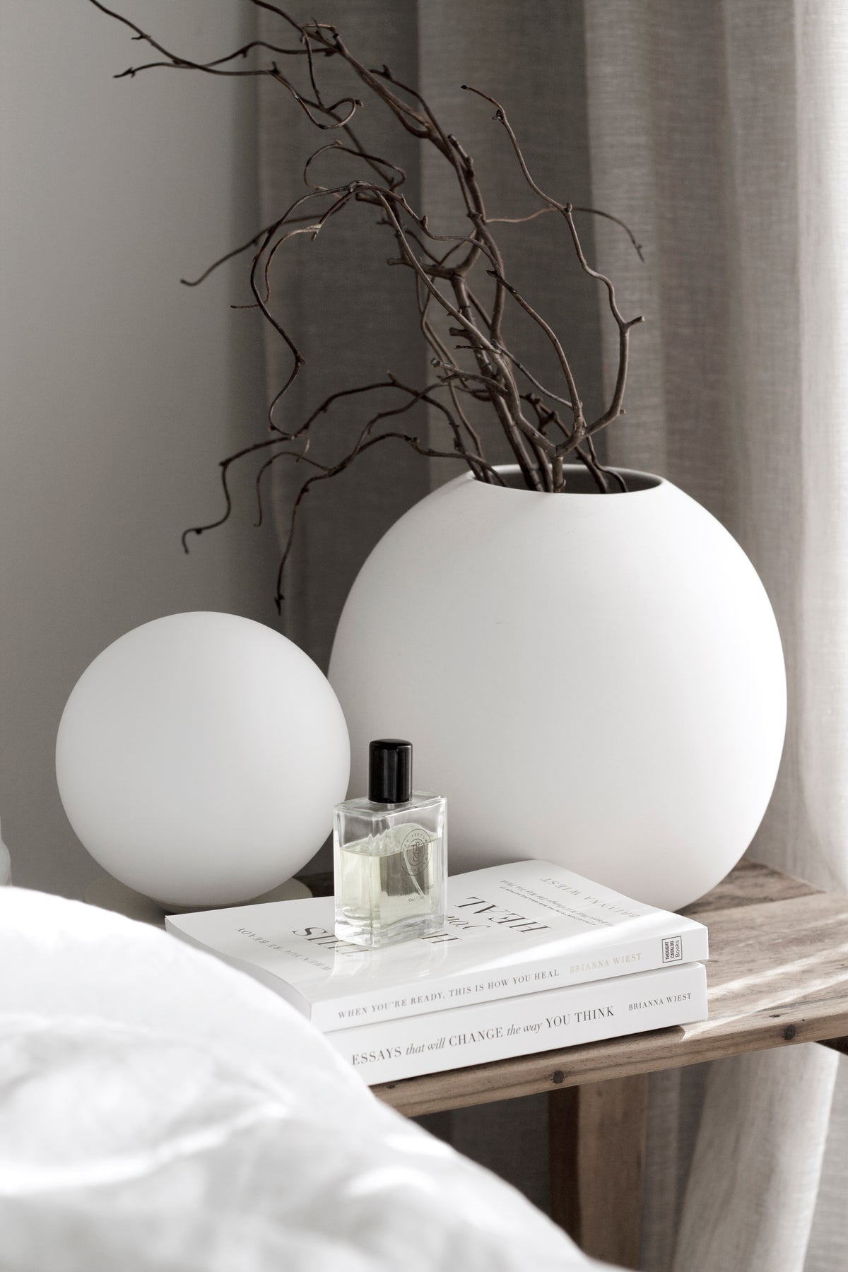 When You're Ready, This Is How You Heal book styled on a bedside table with a candle