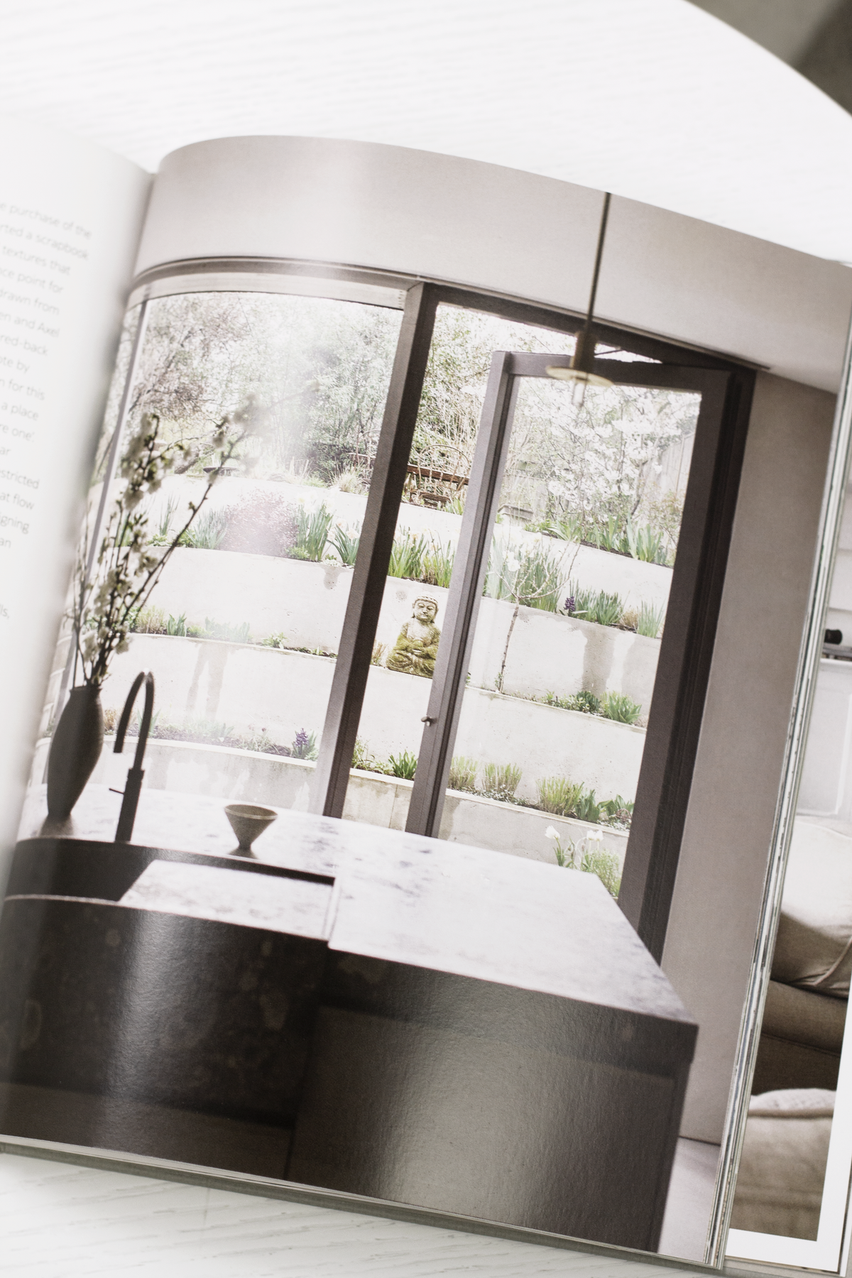 Calm interiors book page spread showing a coastal home