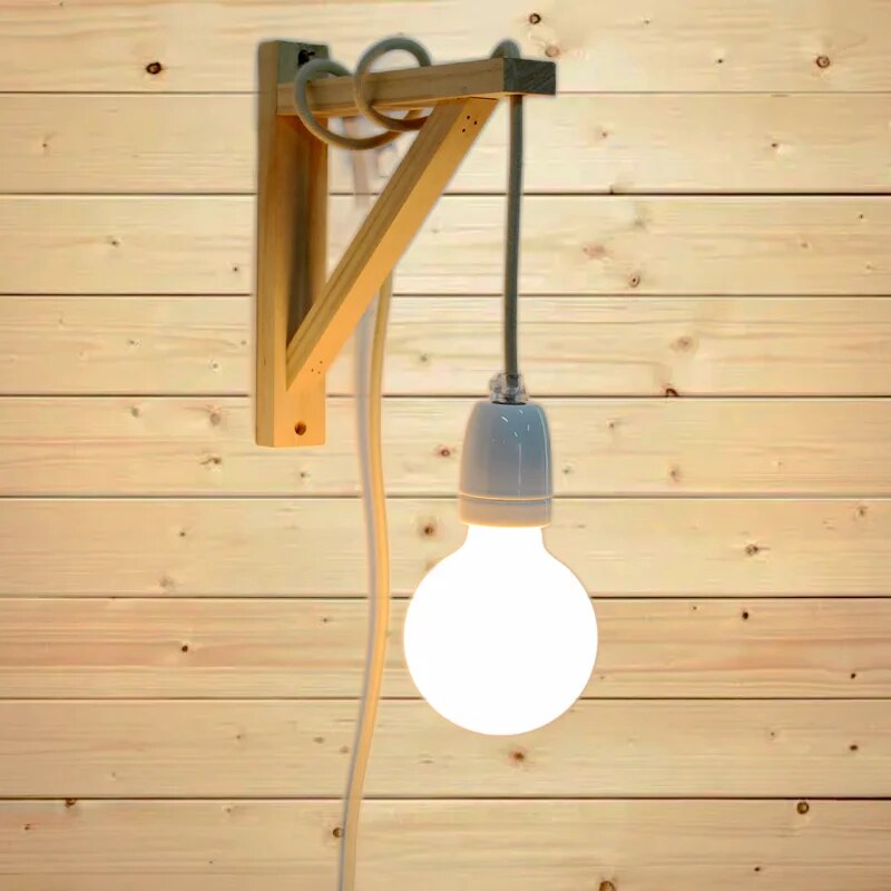 Plug-in pendant hung from a timber wall bracket with a globe bulb against timber boards