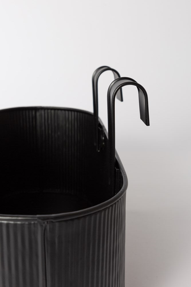 Close view of the charcoal Juno planter and its hooks