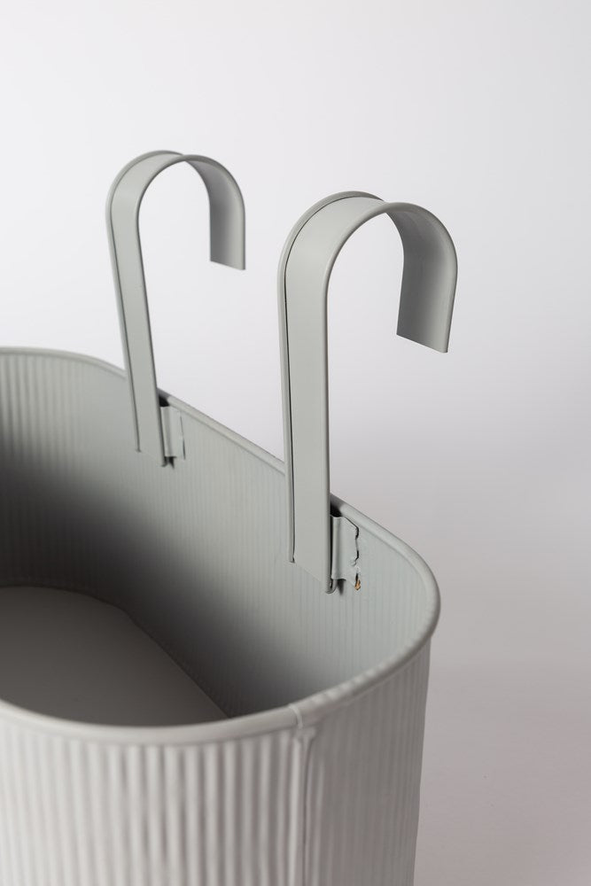 Close view of the light grey Juno planter and its hooks