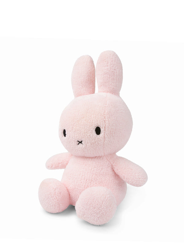 An extra soft Miffy Sitting Terry Pink (33cm) bunny stuffed animal sitting on a white surface. (Mr Maria)