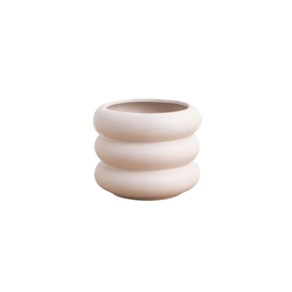 Beige ceramic planter with stacked ring design on a light gray background
