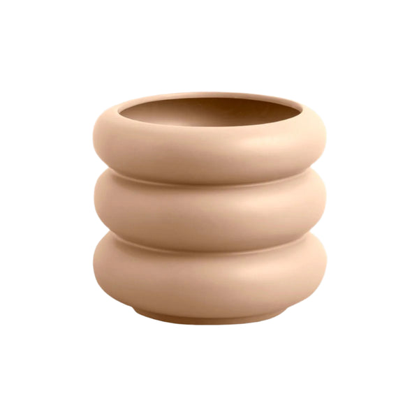 Beige ceramic planter with stacked design on a light gray background