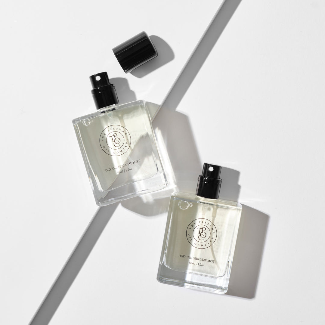Two perfume oil bottles with angled glass shapes in bright light