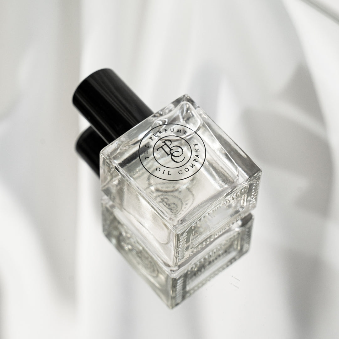 Roll-on perfume oil bottle lying on soft white fabric