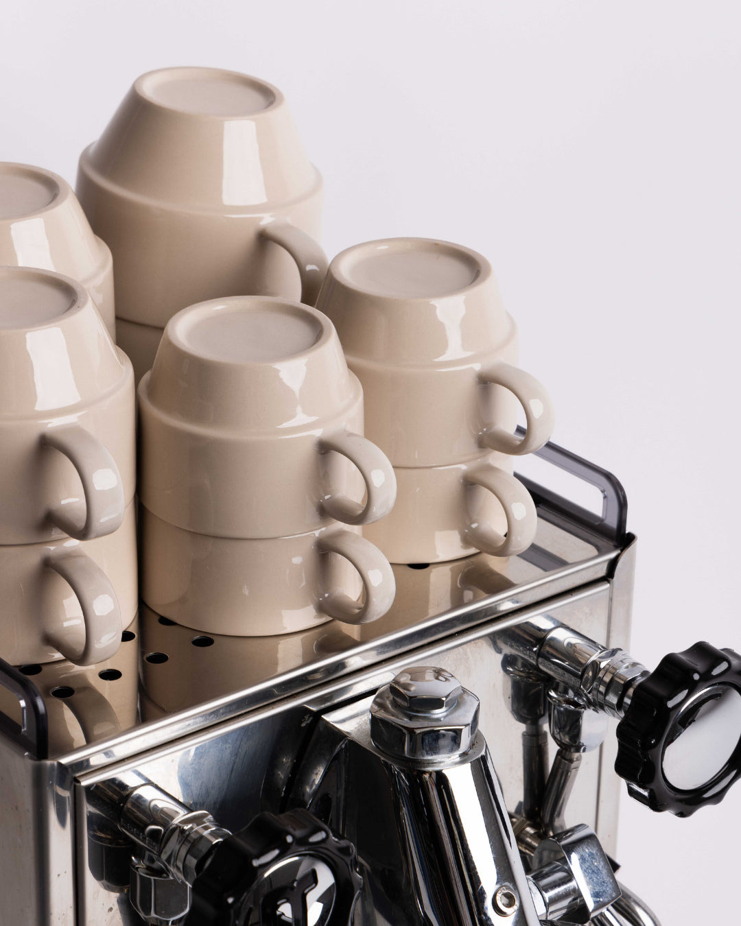 Stacks of Hudson Mugs on top of an espresso machine