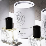 Three bottles of The Perfume Oil Collection Gift Set - Floral from The Perfume Oil Company sitting next to each other on a white surface, exuding a captivating fragrance.