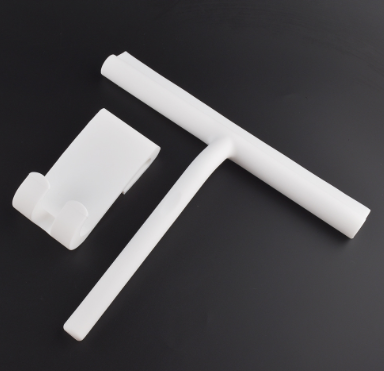 White silicone squeegee with its separate hook on a dark background