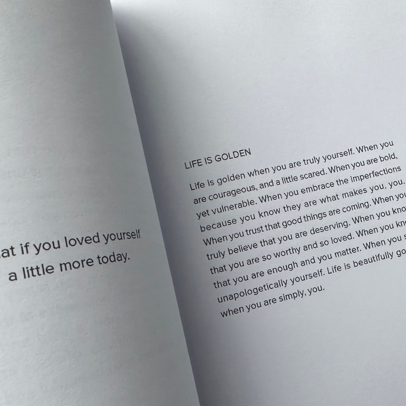 An EVERYDAY MOMENTS book with magical text on it, capturing everyday moments and promoting self-love, by Lisa Buscomb.