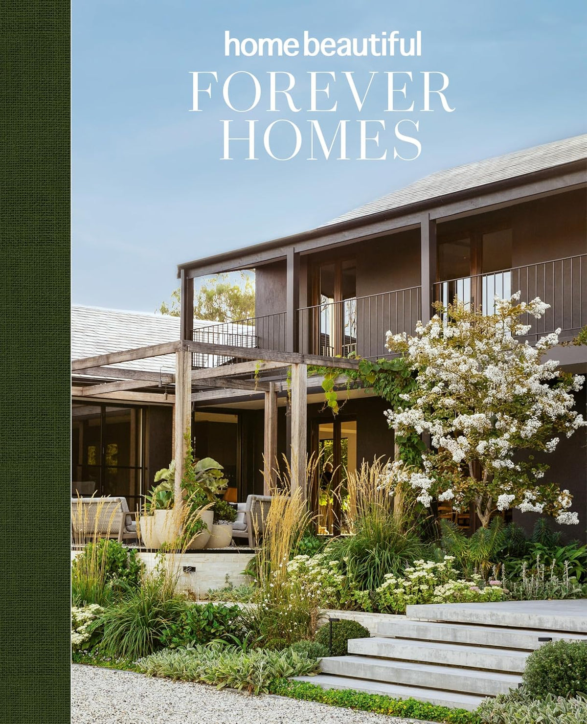 Forever Homes by Home Beautiful, cover showing a timber house behind a white flowering garden