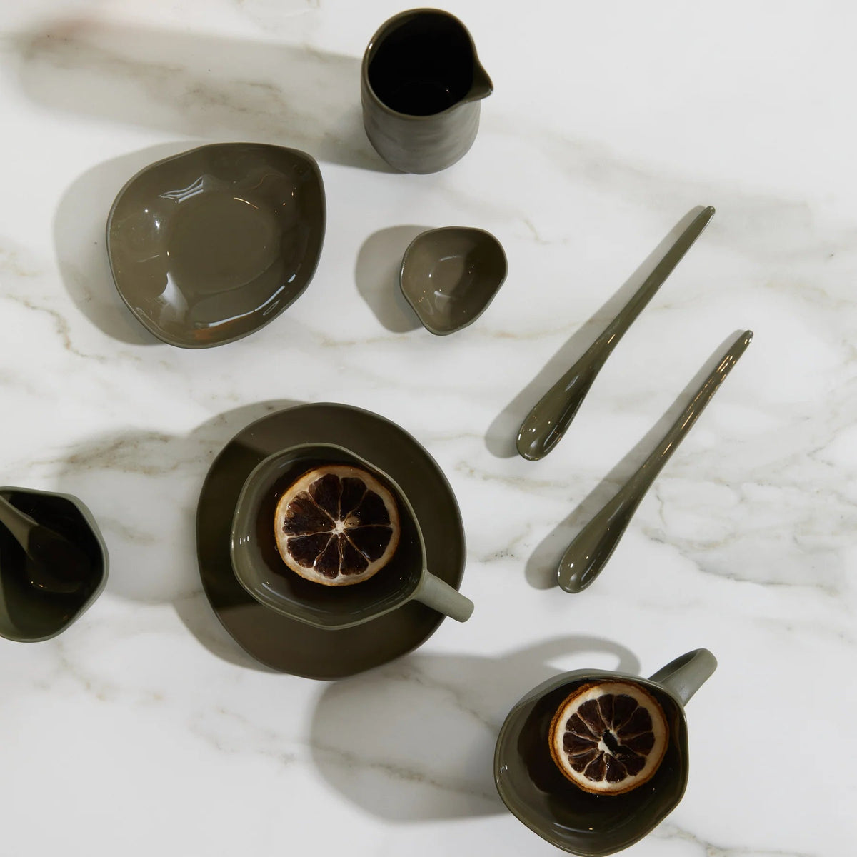 Haan Round Dish styled on a dining table with cutlery