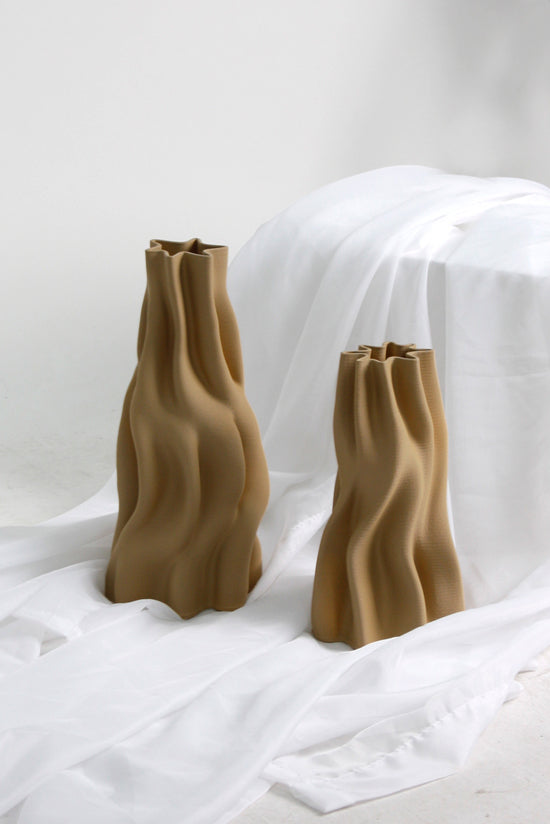 The small and large Anouk vases together on draped white fabric
