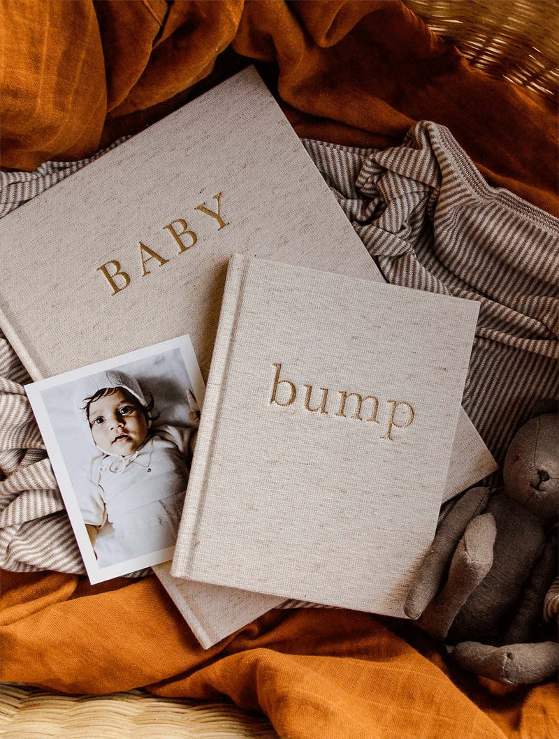 Oatmeal Write To Me Baby journal with the Bump pregnancy journal and baby photos on rust fabric