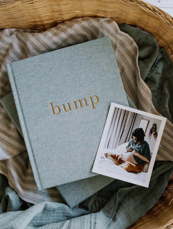 Seafoam Bump journal with a baby photo on a knitted blanket in a woven basket