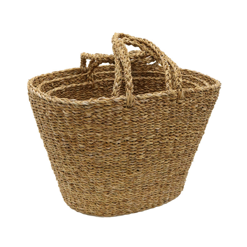 Woven seagrass shopping basket with plaited handles, nested with a second bag inside