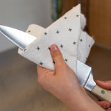 Good Change reusable bamboo towel being used to clean a knife