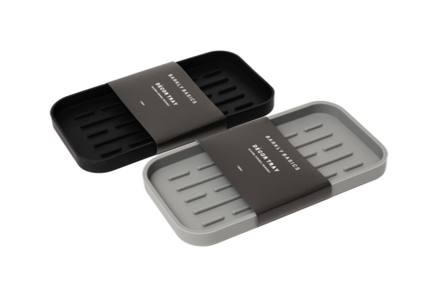 A Barkly Basics silicone dish tray with two compartments for hand washing and storing kitchen sponges.