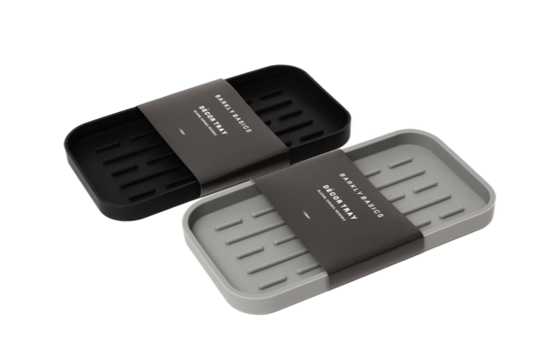 A Barkly Basics silicone dish tray with two compartments for hand washing and storing kitchen sponges.