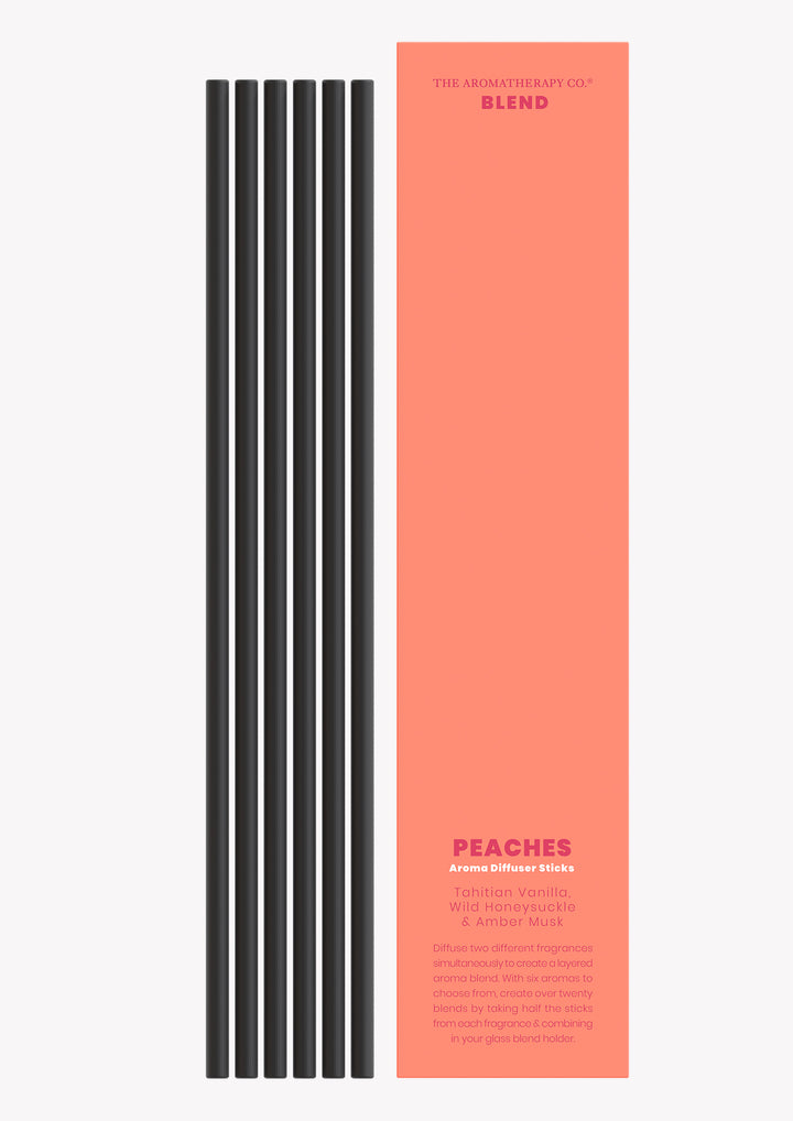 Peaches aroma sticks with the black reeds laid beside the coral Blend sleeve