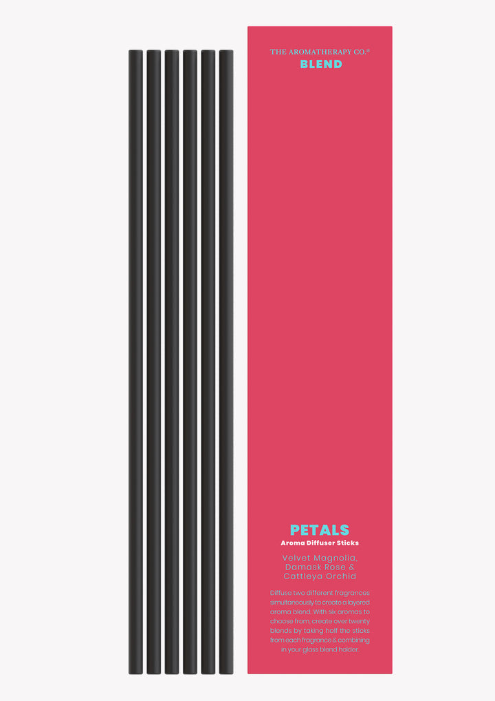 Petals aroma sticks with the black reeds laid beside the deep pink Blend sleeve