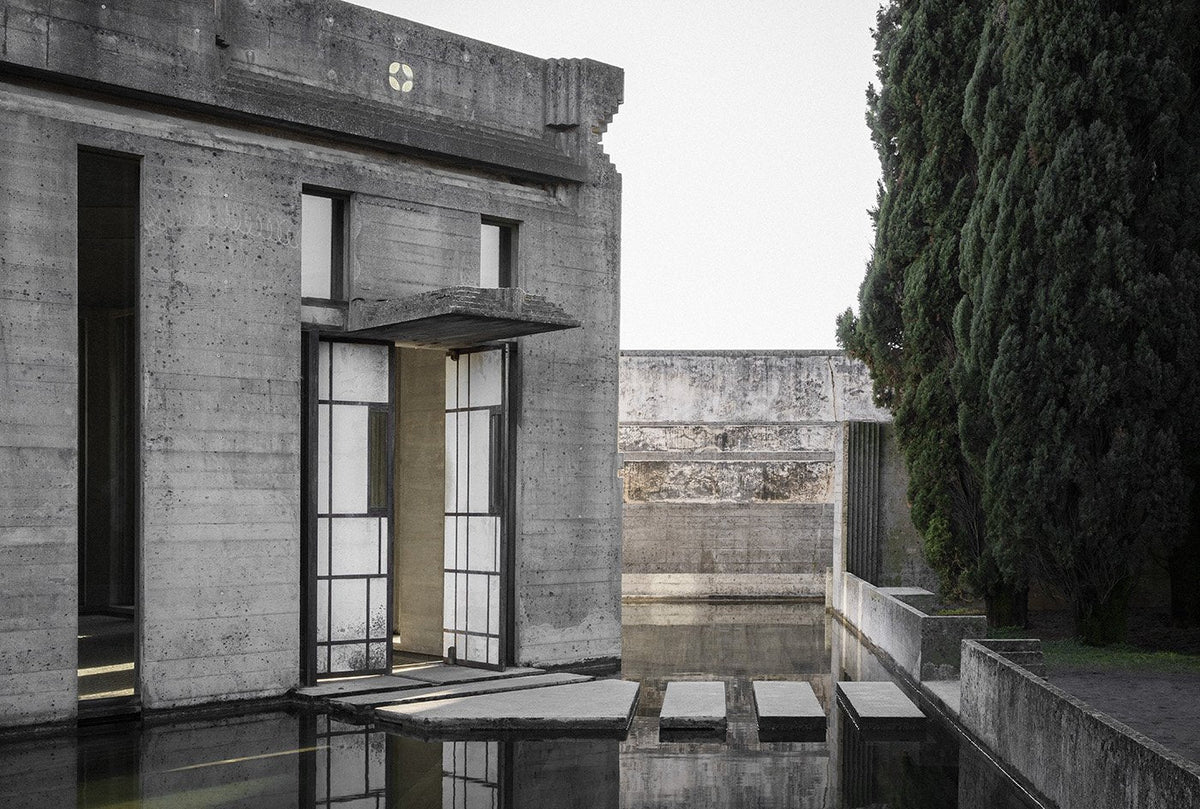 Project featured in the book: a concrete architectural space beside still water